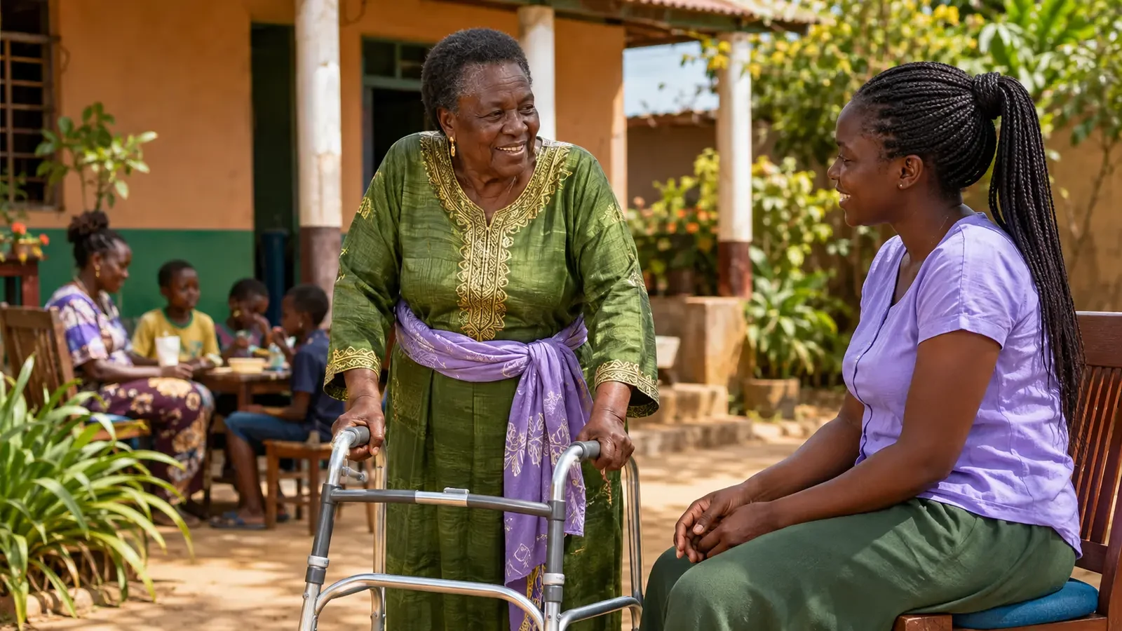 An older Black Ugandan woman using a walking aid speaking with a younger woman in a community setting